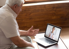 elderly patient talking to a physician via video chat
