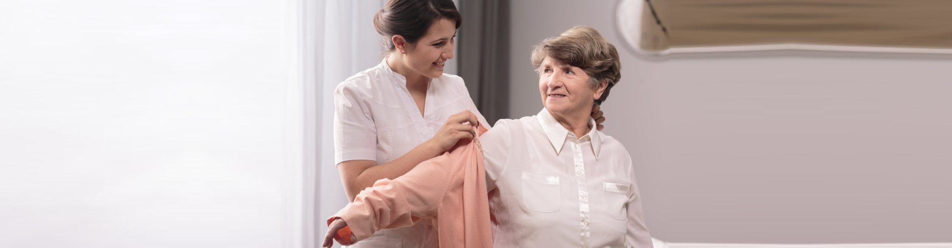 a caregiver assisting an elderly woman